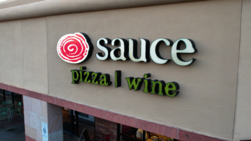 sauce pizza and wine franchise logo on building