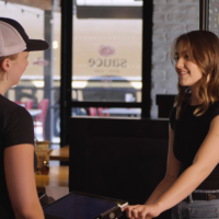 Sauce employee serving a guest