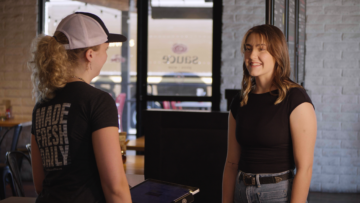 Sauce Pizza and Wine staff greeting a guest